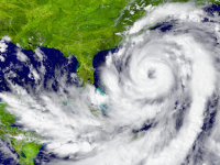 A satellite image of a hurricane swirling between Florida and Cuba