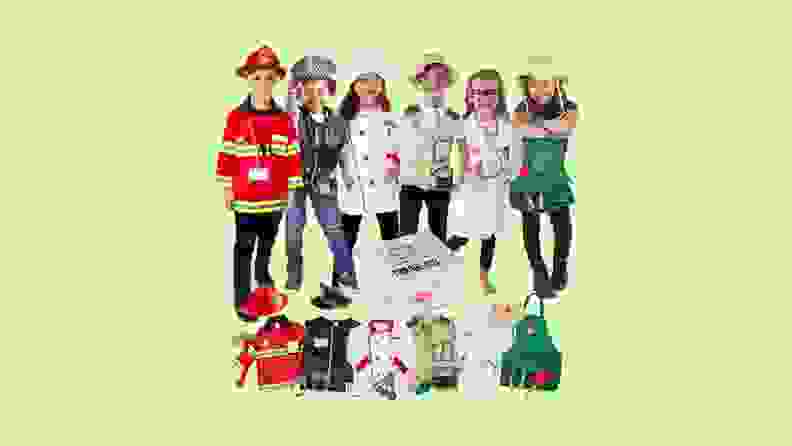 A group of kids wearing all sorts of costumes with a costume storage box in the middle and each individual costume below.