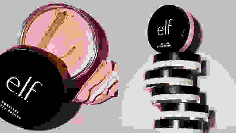 On the left: The E.L.F Cosmetics Poreless Putty Primer sits on a light pink background. The circle container has its black cap off to reveal a light pink putty. On the right: A stack of the E.L.F Cosmetics Poreless Putty Primers stands against a light pink background. There are six total and the top one is propped up and faces out toward the camera.