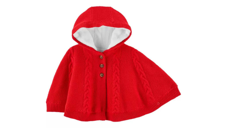 An image of a toddler-sized bright red knitted poncho with a fleece lining.