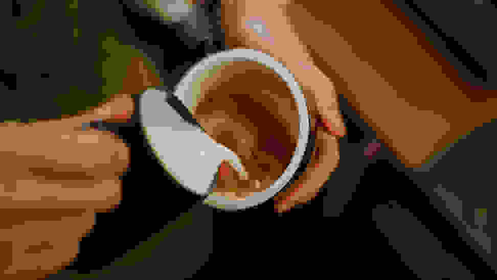 Foamed milk being poured into a cup of espresso coffee