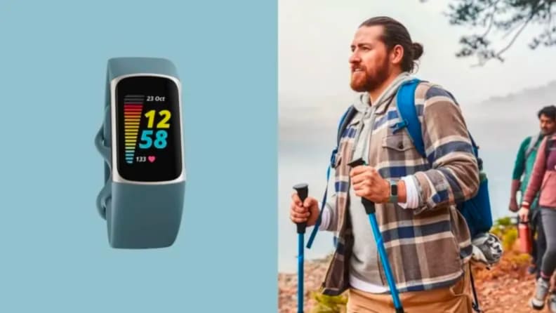 A person hikes with a Fitbit on their wrist.