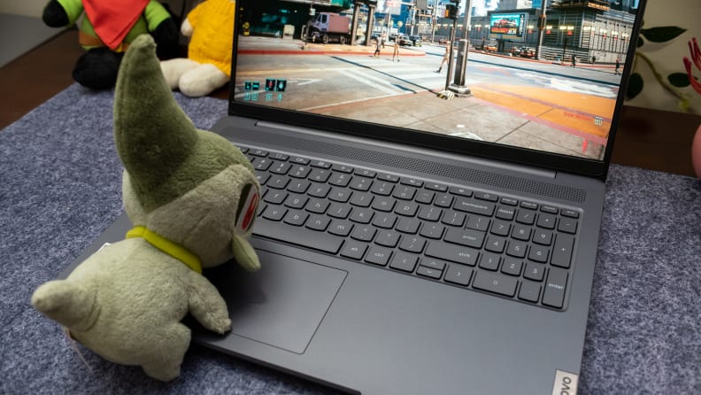 An open Lenovo Ideapad Gaming Chromebook with a stuffed animal on its keyboard, enjoying the fast Wi-Fi.