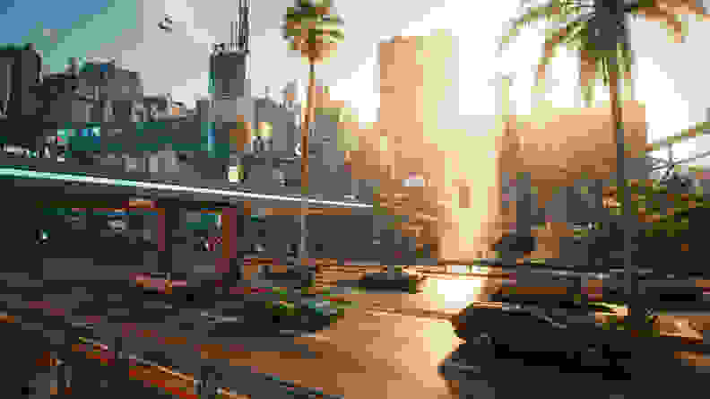A screenshot of Cyberpunk 2077, showing Night City in the daytime.