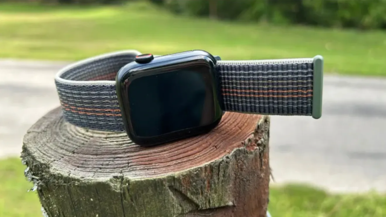 Apple Watch Series 8 on a log, outside.