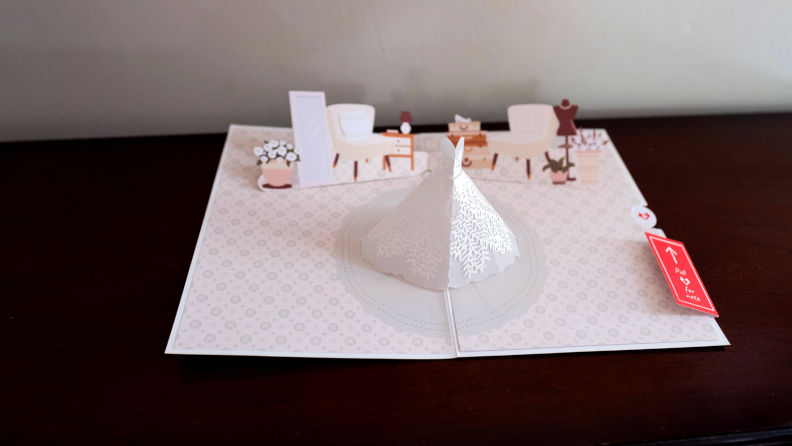 Wedding card with 3-D white dress in the middle.