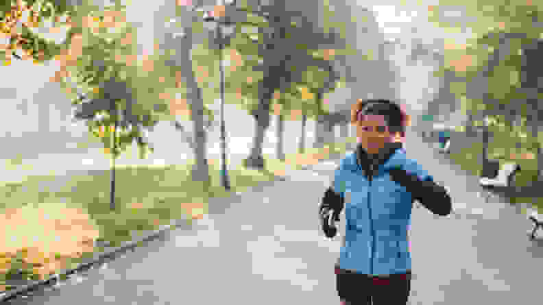 A woman jogging through a park.