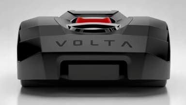 A black robot lawn mower that says VOLTA across the side