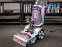 A person using a Bissell carpet cleaner