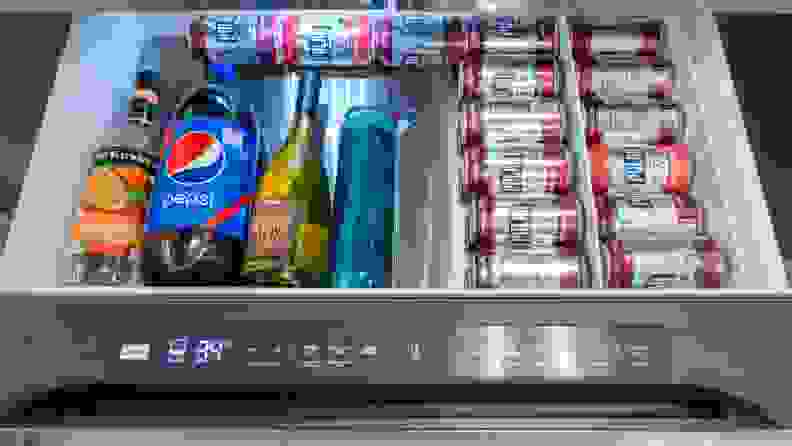 Canned beverages, bottles of alcohol and bottle of soda and water inside of flex drawers.