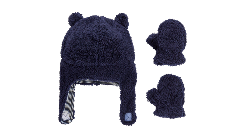 An image of a sherpa blue hat with ears and flaps, and a pair of blue sherpa mittens.