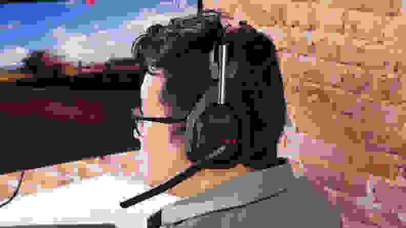 A man wearing a black gaming headset