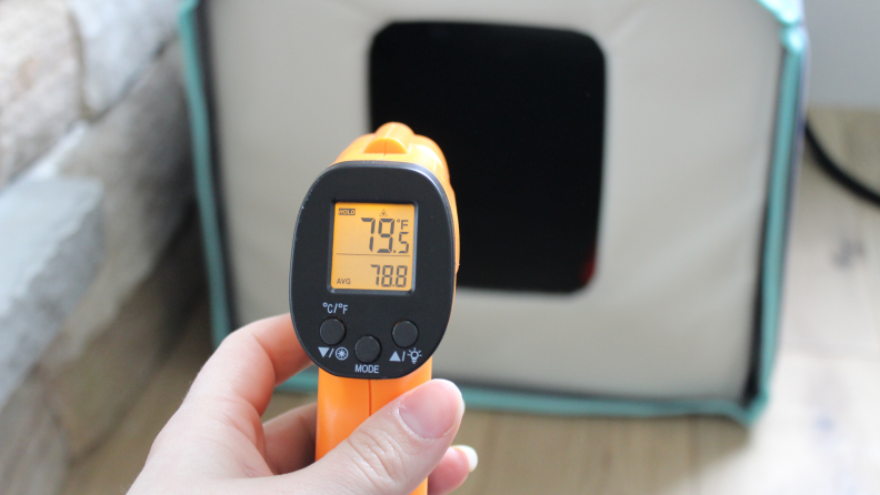 An infrared thermometer showing the temperature from the heating pad.