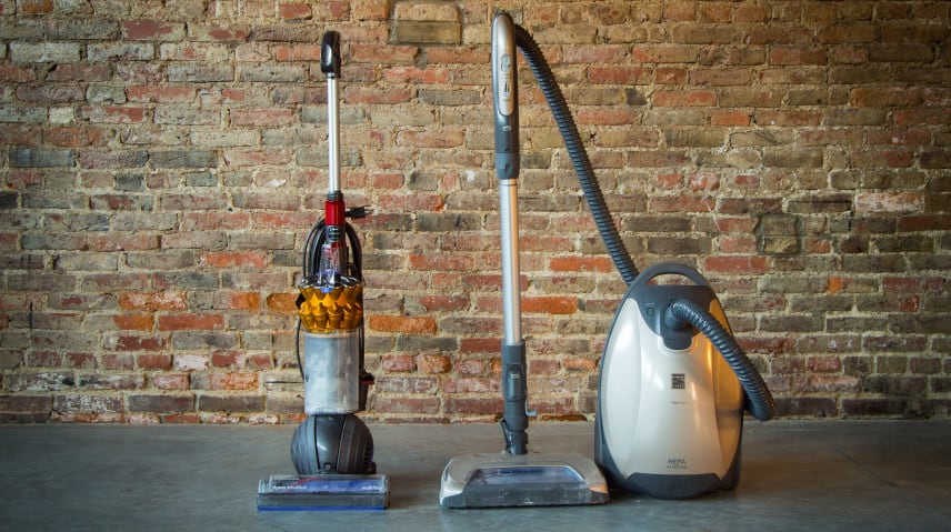 A bagged canister vacuum next to a bagless upright