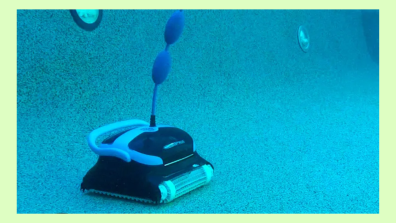 The Dolphin Nautilus CC robot pool cleaner moving around the bottom of an in-ground swimming pool.