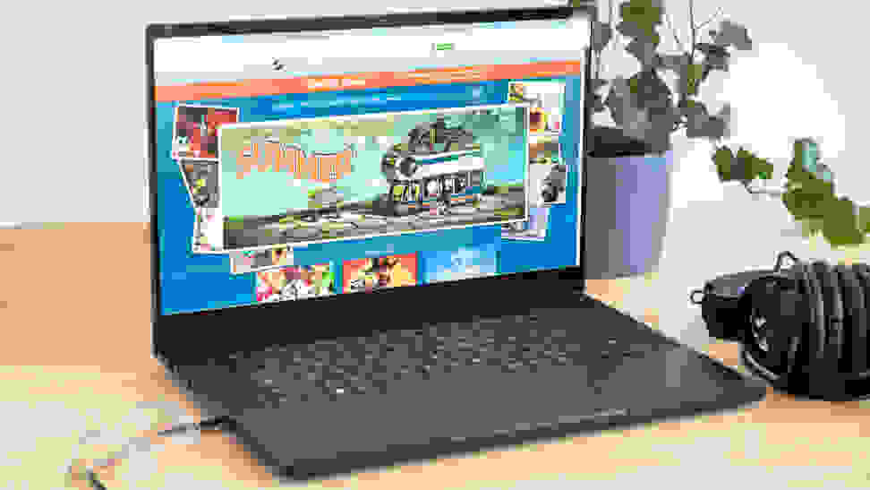 An open and powered on laptop showing a colorful scene on its display.