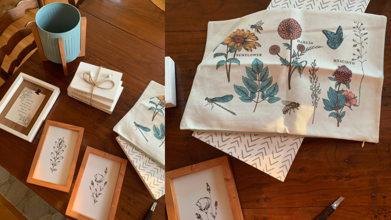 a blue planter, three framed floral prints, stacked wooden prints, a floral pillowcase, laid out on a table