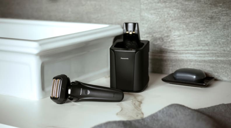 The Panasonic Arc6 6-Blade Shaver on a white marble bathroom counter