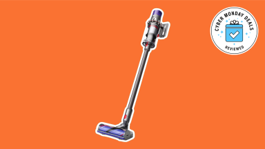A Dyson vacuum against an orange background with a Cyber Monday badge in the corner.