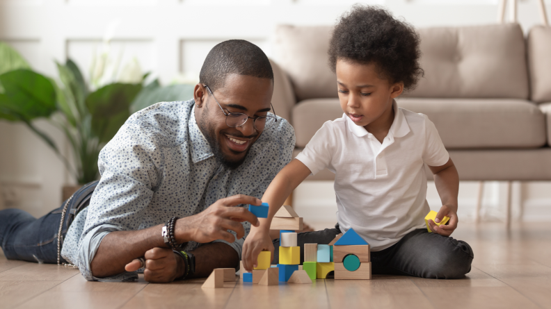 Dad and boy playing blocks together