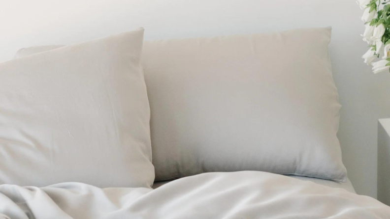 A bed decked out in light gray Cozy Earth bamboo sheets.