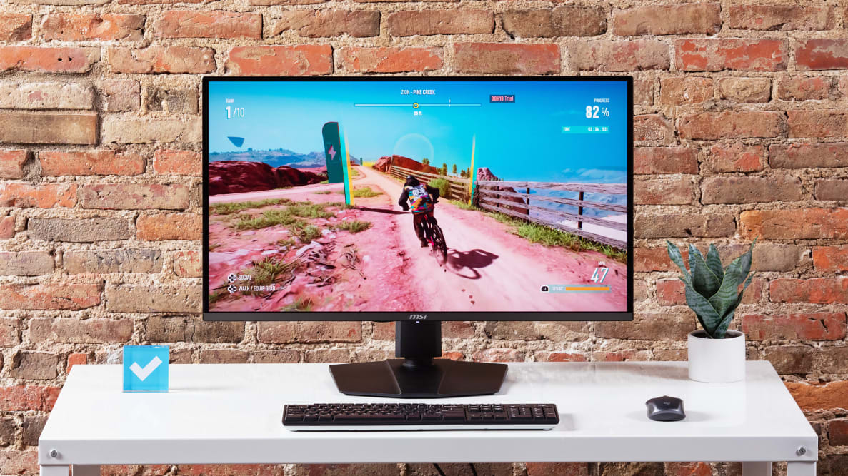 The MSI MPG 321URX gaming monitor on a white desktop.