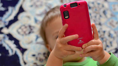 Toddler holding a smartphone