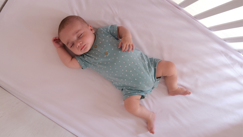 A baby sleeping in a crib.