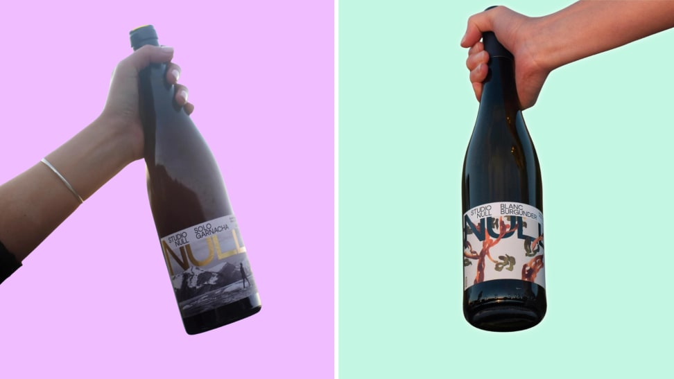 Split image of two hands holding Studio Null wine bottles.