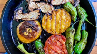 Grilled veggies cooking in a cast-iron grill pan.