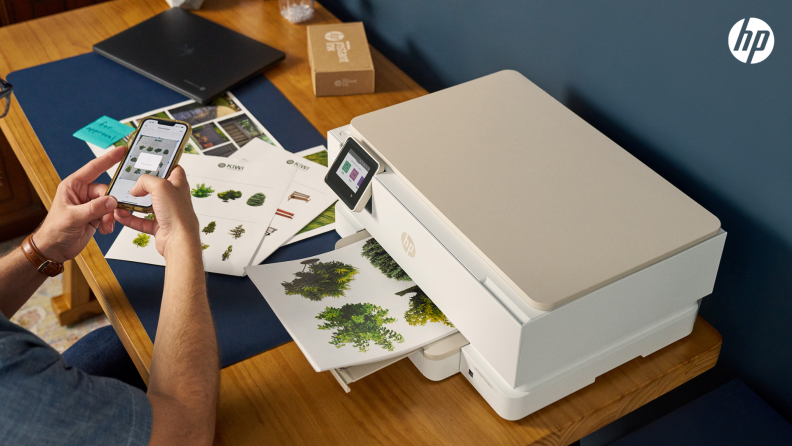 A man prints full-color documents from his phone using an HP printer included in the HP All-In Plan.