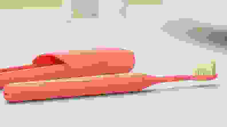Close up of a pink toothbrush.