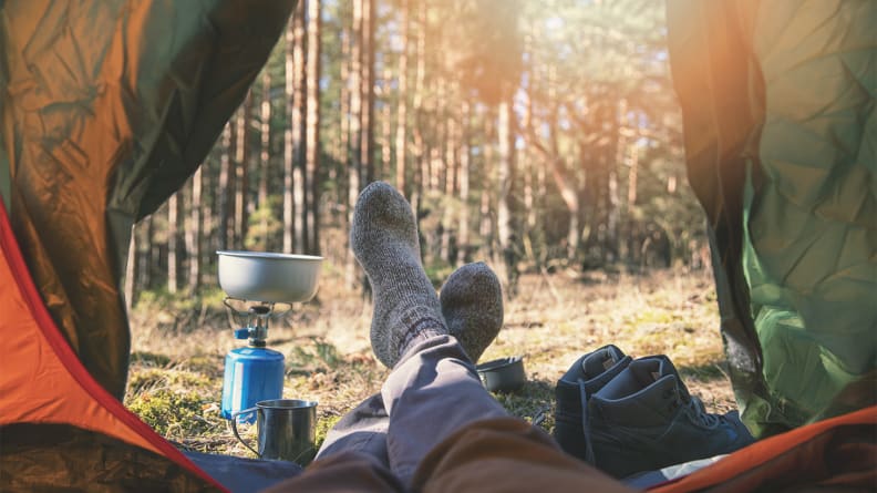 An image of someone hanging their feet out of their tent.