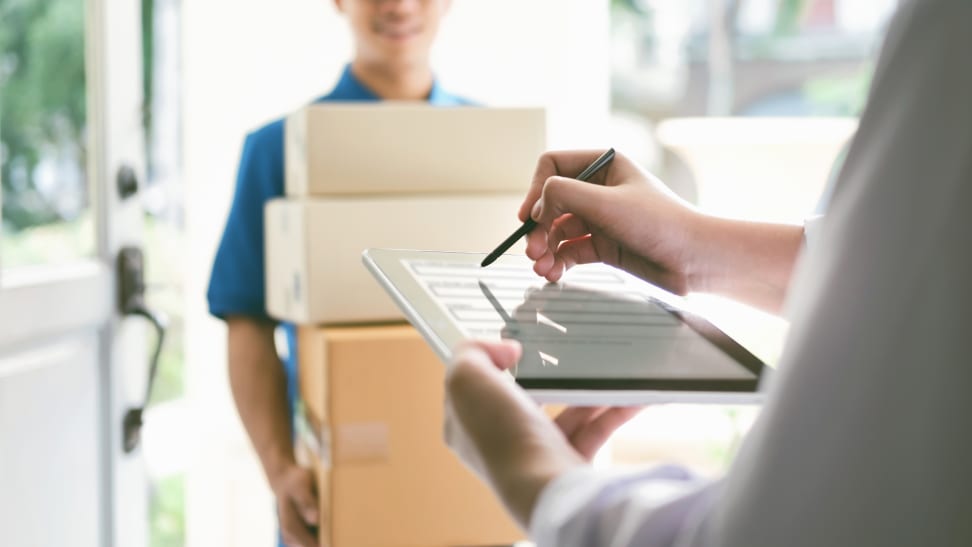 Woman signing for a package