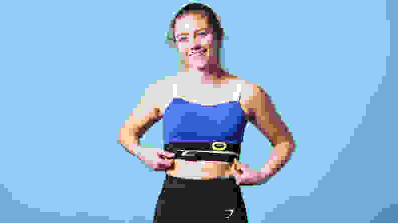 A person blue wearing athletic attire with both the Garmin HRM-Pro and Polar H10 heart rate monitors around their chest.