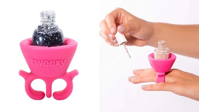 Person using ring-like bottle holder to pain nails