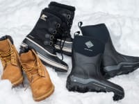 A collection of winter boots in the snow
