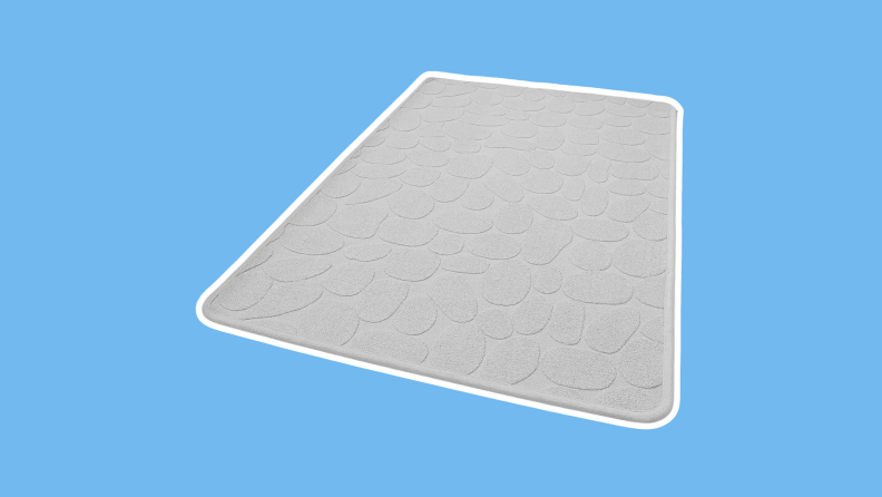 The COCOER Non Slip Bath-Mat in a cream color on a blue background.