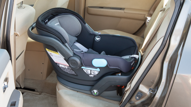 An UppaBaby Mesa car seat installed in the back seat of a car.