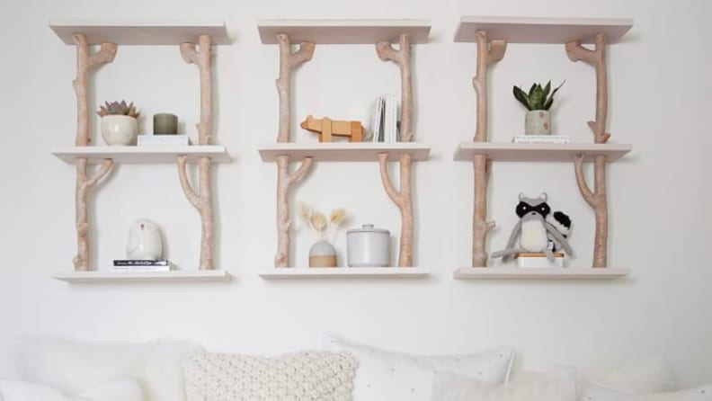 Three birch shelves on a wall.