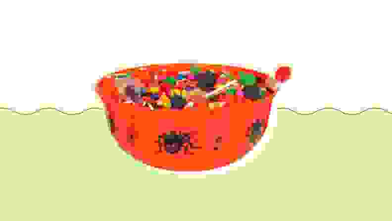 Halloween-themed candy bowl on a green and beige background