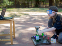 Girl doing science experiment outside