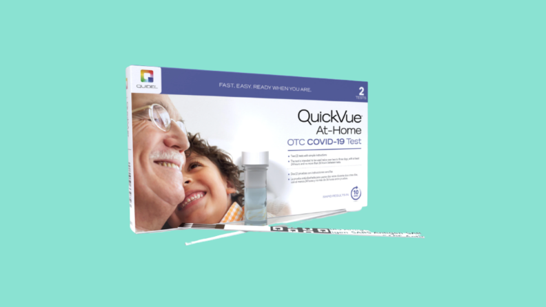 Box of QuickVue Covid-19 test against blue background