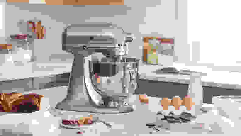 A KitchenAid Five-Quart Artisan Series Tilt-Head stand mixer being used in a kitchen.