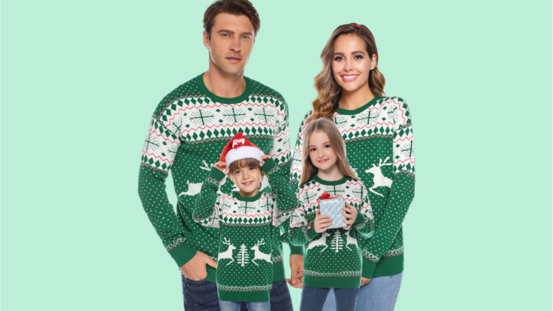 A set of matching green fair isle sweaters with reindeer on them.