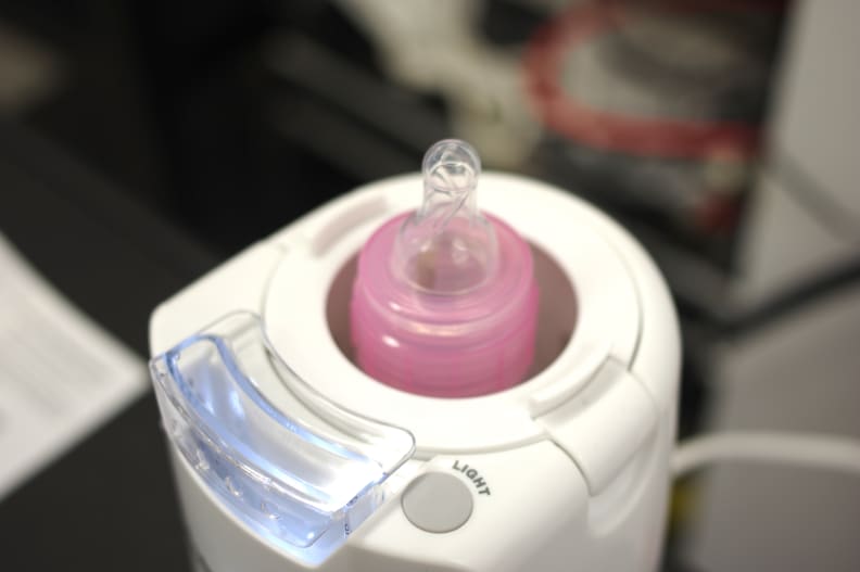 A bottle inside a baby bottle warmer.