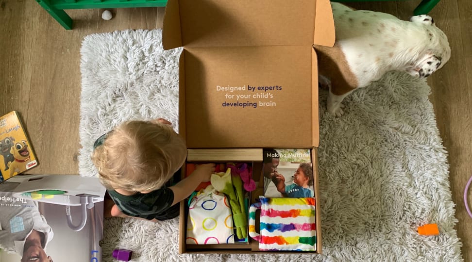 A child opens a box of Lovevery toys