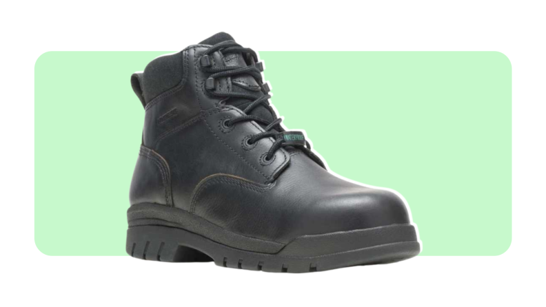 A black leather boot with high laces. Picture featured on a green and white background.