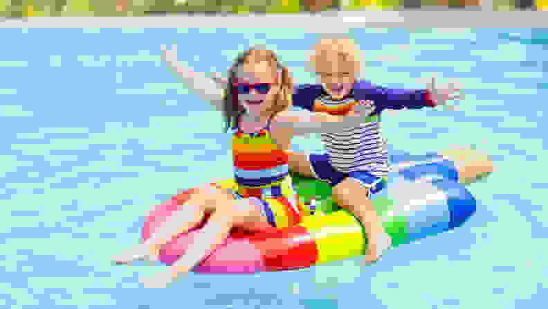 A photo of two children on a pool float.