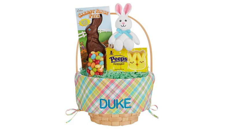 A gingham Easter basket with a child's name embroidered on it with a big chocolate bunny and other sweets.